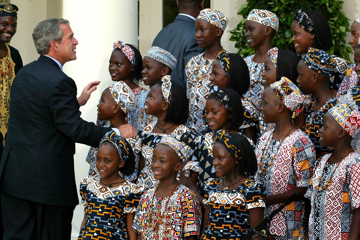 Former U.S. President George W. Bush with the Watoto Children’s Choir of Uganda, composed of orphans of AIDS or conflict, during a Rose Garden performance at the White House on June 10, 2003, in Washington, D.C. House Republicans are threatening to not reauthorize President’s George Bush’s long-successful AIDS relief program PEPFAR, which has saved millions of lives and served as a symbol of America’s moral leadership in the world, unless abortion-related restrictions are added.  (DOUG MILLS)