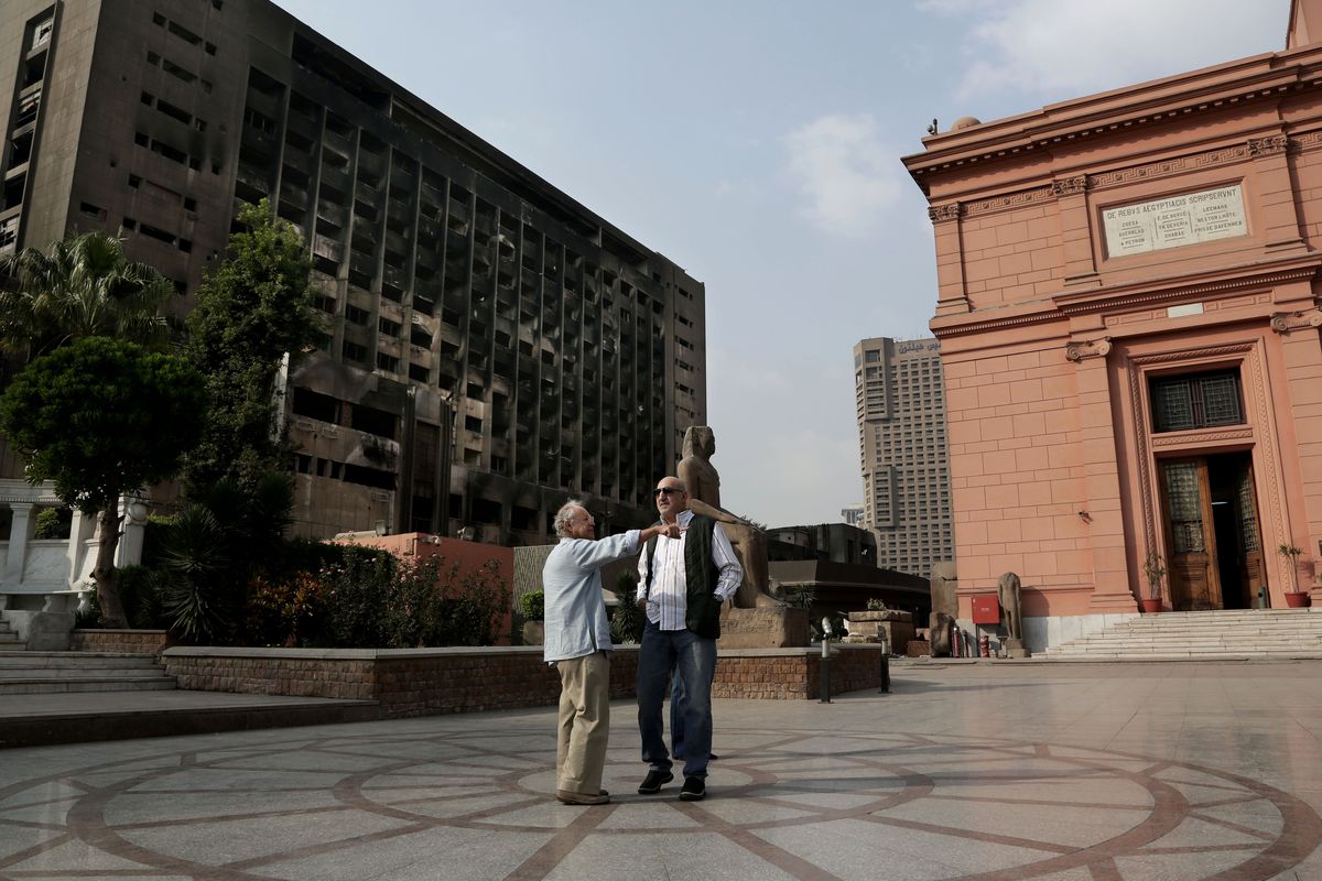 The Egyptian Museum, at right, is located in Cairo’s Tahrir Square next to the former headquarters of Hosni Mubarak’s National Democratic Party, at left, which was burned during the 2011 uprising. Plans are being drawn up to demolish the burned building and create an exhibition garden for the museum. (Associated Press)