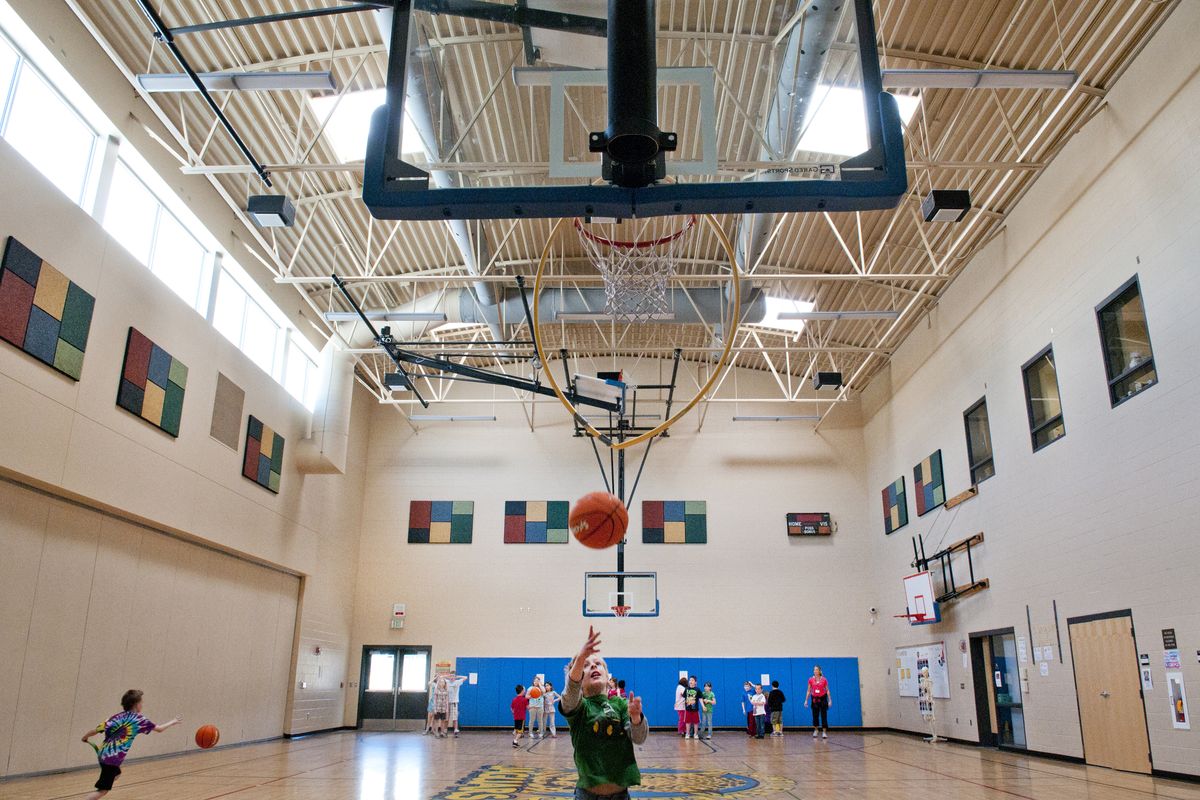 Students run basketball drills in physical education class Wednesday at Lincoln Heights Elementary School. The school is a “green” building, designed to save electricity, water and building materials. (Jesse Tinsley)