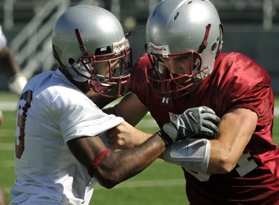WSU  receiver Jared Karstetter, right, squares off against defensive back Tyrone Justin during a mid-August practice.  (Dan Pelle / The Spokesman-Review)