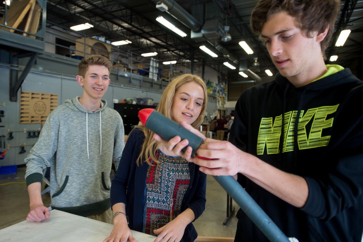 From left: Kaleb Cerar, Bella Memeo and Kyle Graves demonstrate how the rocket they built deploys a parachute on Friday, April 21, 2017, at Riverpoint Academy in Spokane, Wash. The trio qualified for a national competition on rocket building called the Team America Rocket Challenge. (Tyler Tjomsland / The Spokesman-Review)