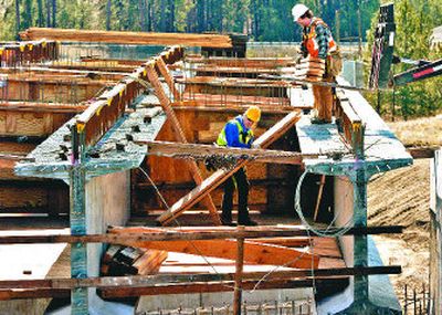 
Workers put the pieces together Wednesday for a North-South Freeway bridge at Market Street and Hawthorne Road in Mead.
 (The Spokesman-Review)