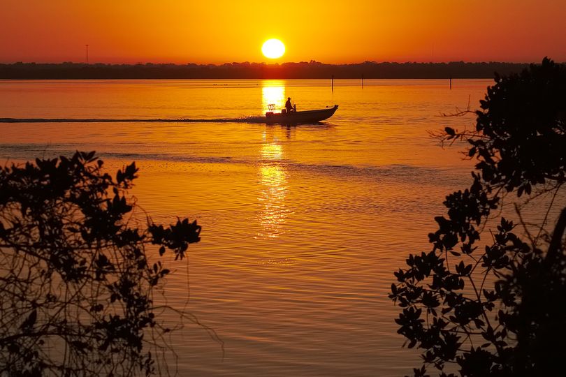 A boater cruises at sunrise near Bonita Springs, Fla., where temperatures in the area are expected to reach 80 degrees, Tuesday morning, March 4, 2014. (J. Ake / Associated Press)