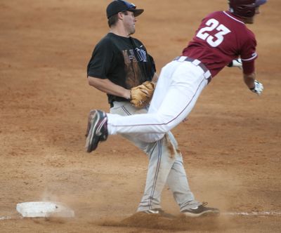 Kansas State's Kent Urban (17) trips up Washington State's Matt Argyropoulos (23) after applying the tag at first base during the third inning of their NCAA Regional. (Beth Hall / Fr129439 Ap)