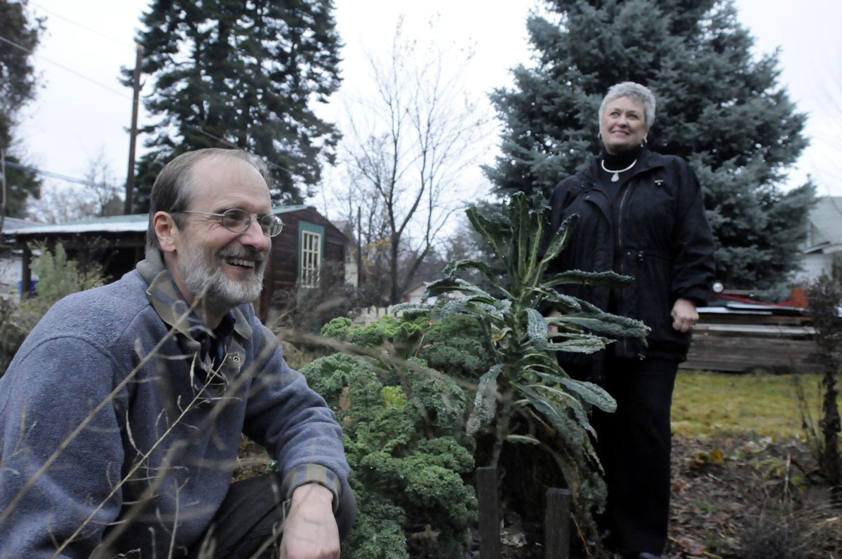 Richard Kuhnel, left, and Karen Lanphear stand in Kuhnel’s expanded and still-producing garden at his house in Sandpoint.  (Photos by JESSE TINSLEY / The Spokesman-Review)