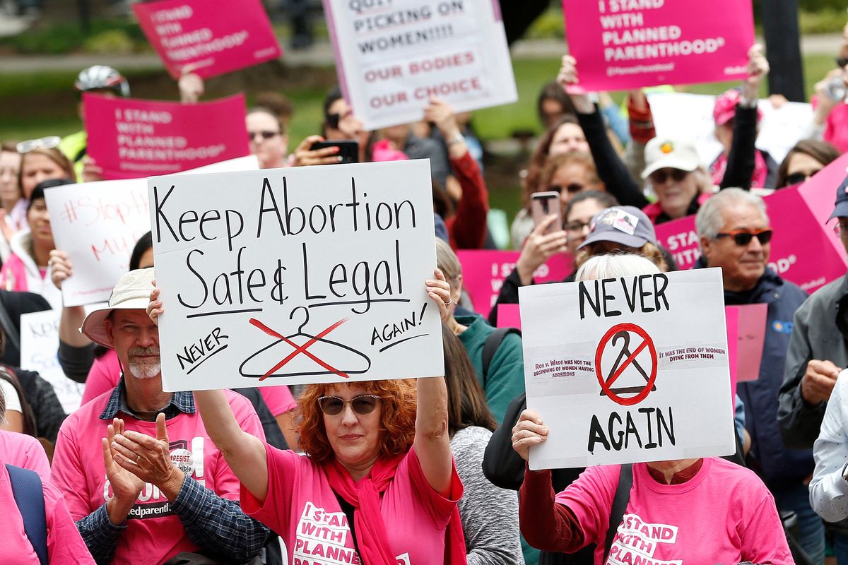 FILE - People rally in support of abortion rights at the state Capitol in Sacramento, Calif., May 21, 2019. On Wednesday Dec. 8, 2021, a group of abortion providers and advocacy groups recommended California should use public money to bring people here from other states for abortion services should the U.S. Supreme Court overturn Roe v. Wade. The report has the backing of key legislative leaders, including Senate President Pro Team Toni Atkins, a Democrat.  (Rich Pedroncelli)