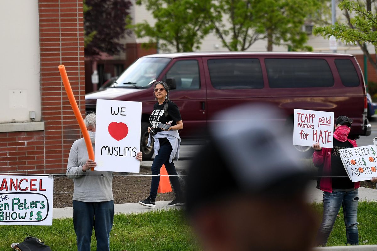Christina Davis, right, with Stronger Together Spokane, holds anti-Church at Planned Parenthood signs as Christine Stickelmeyer, with The Church at Planned Parenthood, walks to the other side of the street to check out the counter-protest during a The Church at Planned Parenthood protest rally and church service on Tuesday, May 19, 2020, at Planned Parenthood