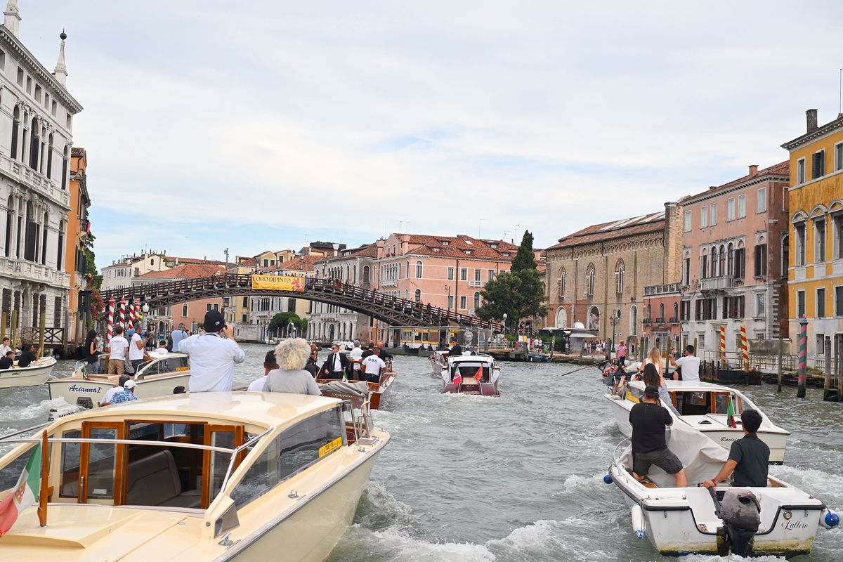 The boat Moa, center, transports Amazon’s founder Jeff Bezos along the Grand Canal on his wedding day in Venice on Friday. (Stefano Rellandini/Getty Images North America/TNS)