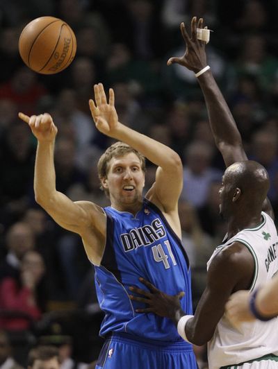 Dirk Nowitzki, left, scored 29 points to lead the Dallas Mavericks to a 101-97 victory over the Celtics in Boston. (Associated Press)