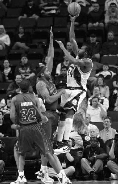 
Seattle's Chris Wilcox lofts a shot over Detroit's Rasheed Wallace.
 (Associated Press / The Spokesman-Review)
