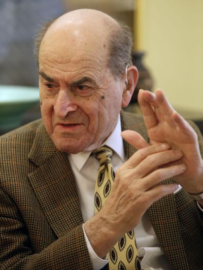 In this 2014  photo, Dr. Henry Heimlich describes the maneuver he developed to help clear obstructions from the windpipes of choking victims. (Al Behrman / Associated Press)