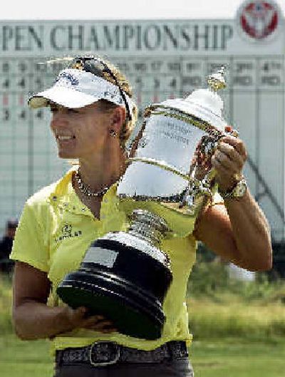 
Annika Sorenstam, who recently became a naturalized U.S. citizen, holds her trophy on the 18th green after winning the U.S. Women's Open. It was her third U.S. Open victory, 10th major of her career and 68th career victory. She has won at least one major in each of the last six years.
 (Associated Press / The Spokesman-Review)