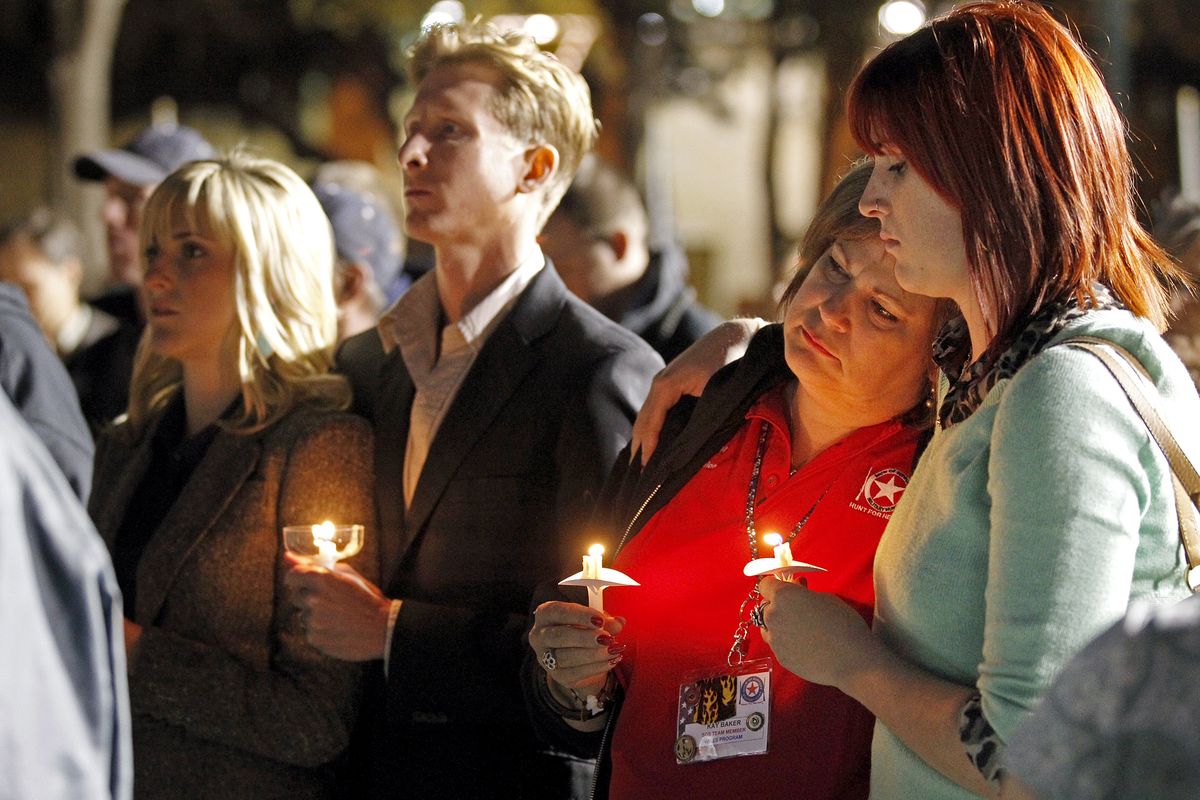 People gather in Centennial Plaza in Midland, Texas on Saturday, Nov. 17, 2012 for a candlelight vigil held in honor of four veterans who were killed when a freight train hit a parade float Thursday. (James Durbin / Midland Reporter-telegram)