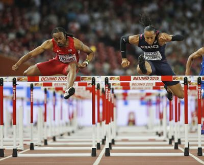 American Aries Merritt, left, competes in a men’s 110 hurdles semifinal. (Associated Press)