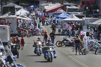 
wo motorcyclists head up the main street of Rosalia after cruising through the 100 Years of Motorcycles Rally on Friday. The annual rally fills the small Eastern Washington town with loud bikes and even louder parties. 
 (Photo by Christopher Anderson / The Spokesman-Review)