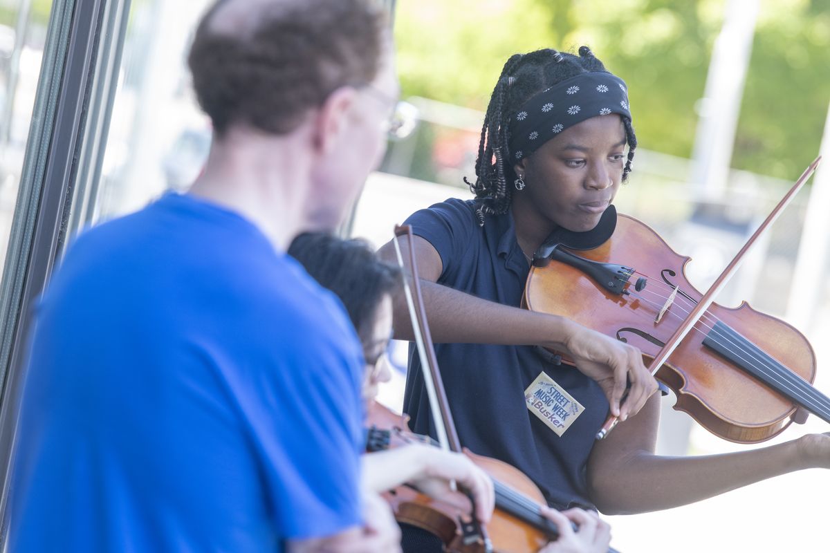 Alexis Merane’ Hart, right, plays viola with the Sforzando Quartet outside the Community Building on Main Avenue in downtown Spokane Monday, June 14, 2021. It was the first time the quartet has performed at Street Music Week, which runs through Friday in the downtown Spokane area.  (Jesse Tinsley/The Spokesman-Review)