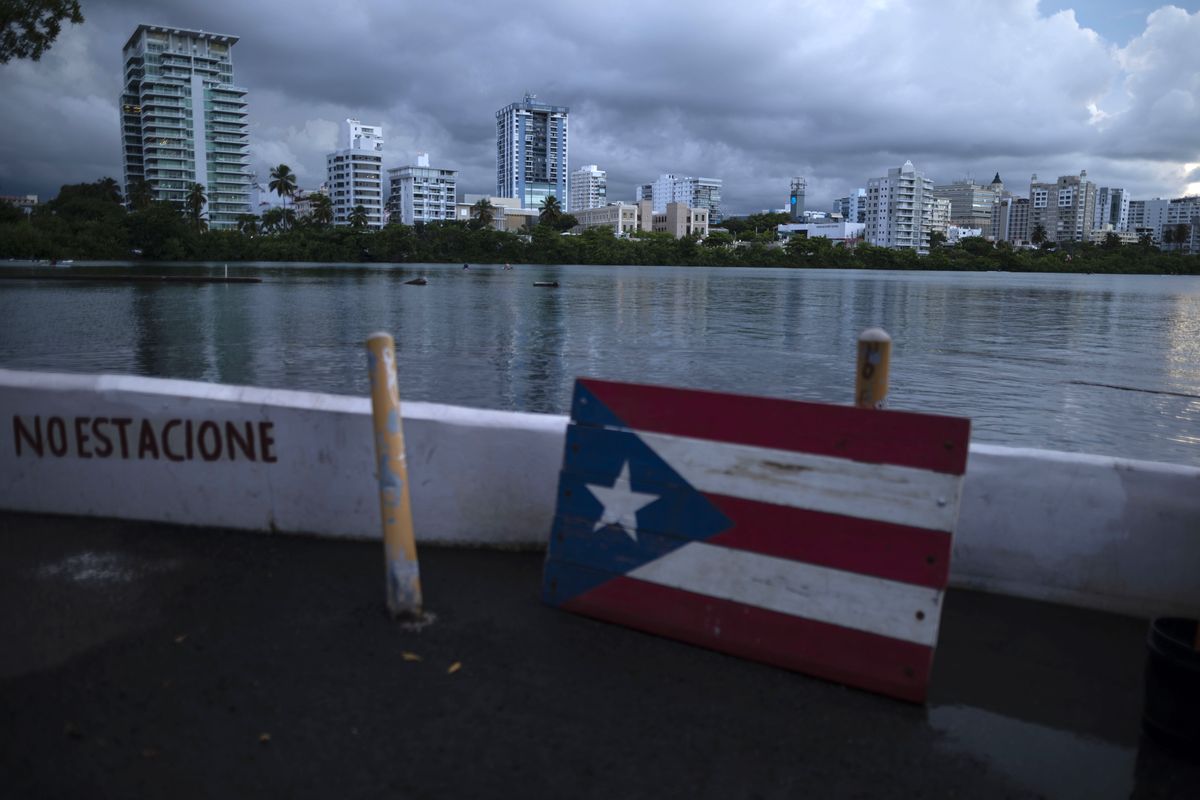A wooden Puerto Rican flag is displayed on the dock of the Condado lagoon, where multiple selective blackouts have been recorded in the past days, in San Juan, Puerto Rico, Thursday, Sept. 30, 2021. Power outages across the island have surged in recent weeks, with some lasting up to several days.  (Carlos Giusti)