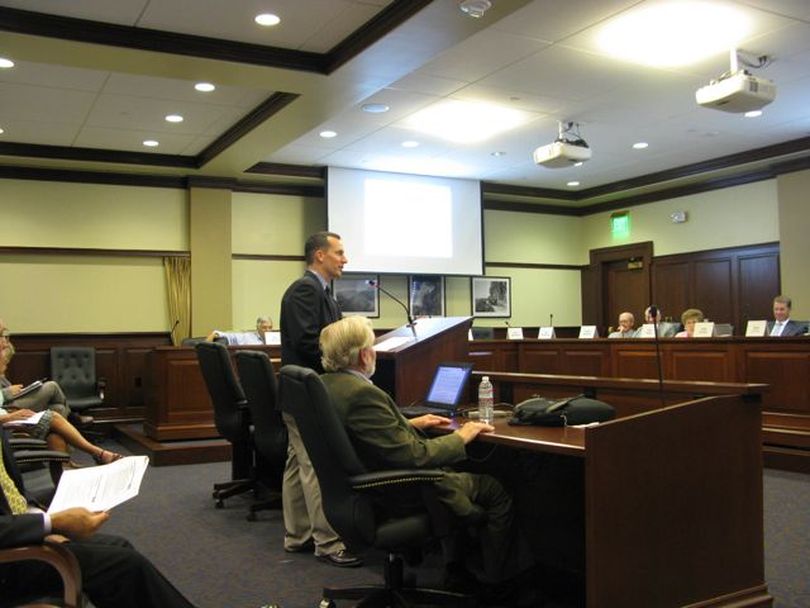 Consultants Patrick Balducci, standing, and Joseph Stowers tell the Idaho governor's transportation funding task force on Tuesday how much more damage heavy trucks do to pavement than cars. (Betsy Russell)