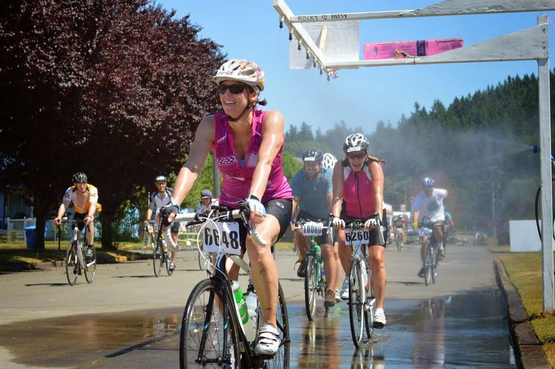 Cyclists cool off in a water spray during the 2014 Seattle to Portland (STP) Bicycle Classic.