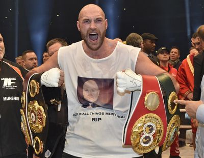 In this Nov. 29, 2015 file photo, Britain’s new world champion Tyson Fury, celebrates with the WBA, IBF, WBO and IBO belts after winning the world heavyweight title fight against Ukraine’s Wladimir Klitschko in Duesseldorf,  Germany. (Martin Meissner / Associated Press)