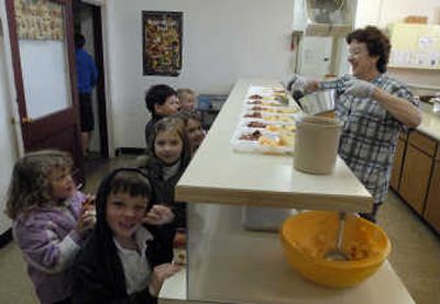 
Carol St. Clair dishes up sweet-and-sour ham for St. Paschal preschool and Educare students. She has cooked at the school for 17 years. The school is closing but the Educare program run by St. Paschal Church will continue.
 (J. BART RAYNIAK Photos / The Spokesman-Review)