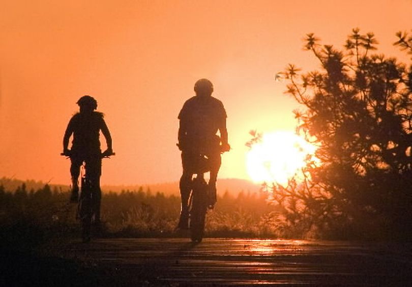 Cyclists enjoy a summer sunset ride along High Drive on Spokane's South Hill.
 (Staff photo)