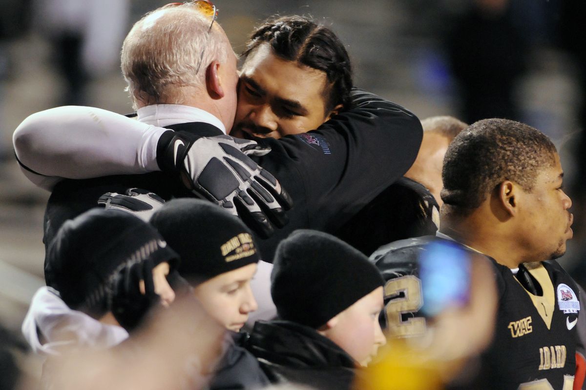 Idaho head coach Robb Akey, left, embraces All-American senior lineman Mike Iupati after the Vandals defeated Bowling Green in the final seconds of the Wednesday, Dec. 30, 2009, Roady