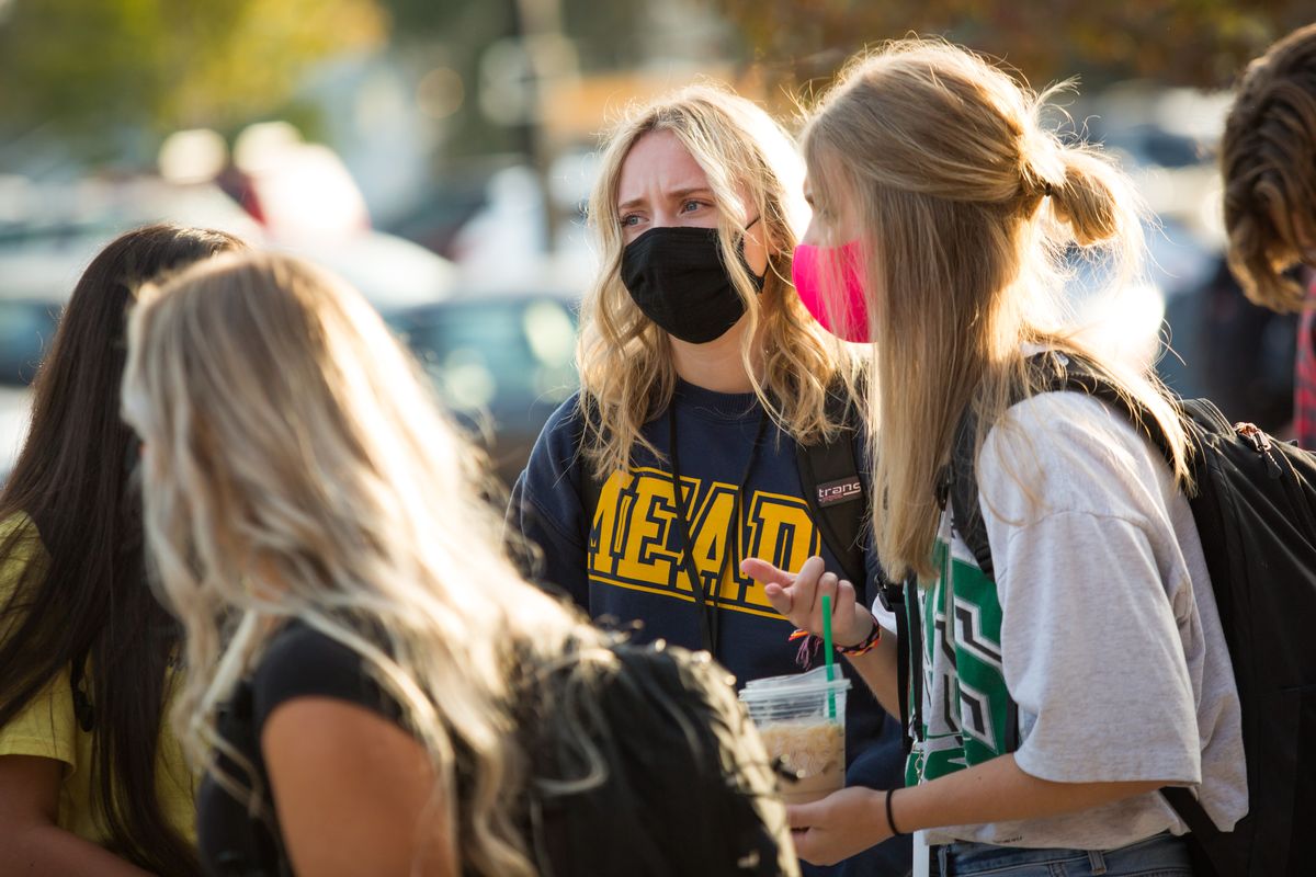 Mead High School junior Delaney Fritz, center, chats with junior Lindsey Krygier while waiting to enter the building Monday.  (Libby Kamrowski/ THE SPOKESMAN-R)