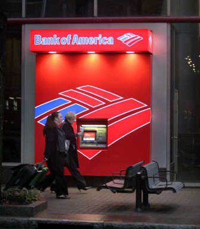 
Pedestrians walk Friday past a Bank of America ATM in Charlotte, N.C., near the bank's corporate headquarters. Associated Press
 (Associated Press / The Spokesman-Review)