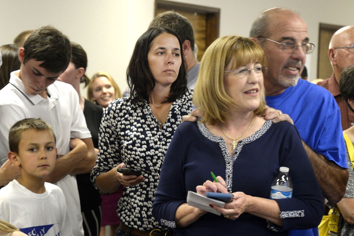 Spokane County Commissioners Shelly O'Quinn, center left, and Nancy McLaughlin, center right, with husband Dave, right, watch the primary election returns, Tuesday, Aug. 2, 2016, at the office of U.S. Rep. Cathy McMorris Rodgers in Spokane. O'Quinn will stand for re-election in November, while recently appointed commissioner McLaughlin was in third place, behind Democrat Candace Mumm and Republican Josh Kern. (Jesse Tinsley / The Spokesman-Review)