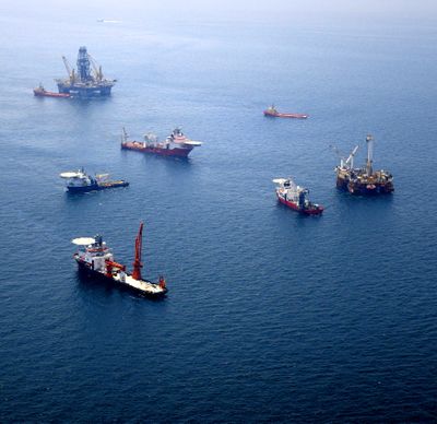 Several boats and two relief platforms – top and far right – are seen at the site of the Deepwater Horizon oil spill.  (Associated Press)