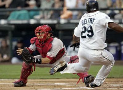 Angels catcher Jeff Mathis waits for the throw as Adrian Beltre scores on Kenji Johjima's double in second inning. Associated Press
 (Associated Press / The Spokesman-Review)
