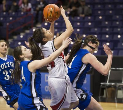 Colton's Kaitlin Druffel, left, and Mckenzie Heaslet, right, put the squeeze on Neah Bay's Rebecca Thompson during the State 1B first round basketball game on Thursday in the Spokane Arena. (Colin Mulvany / The Spokesman-Review)