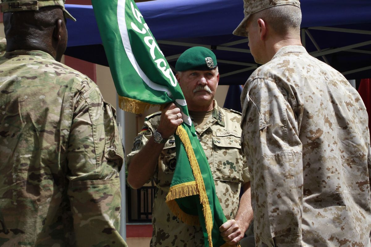 German Gen. Wolf Langheld, commander of NATO Allied Joint Force Command, hands over the flag of International Security Assistance Force to U.S. Gen. John Allen in Kabul, Afghanistan, on Monday. (Associated Press)