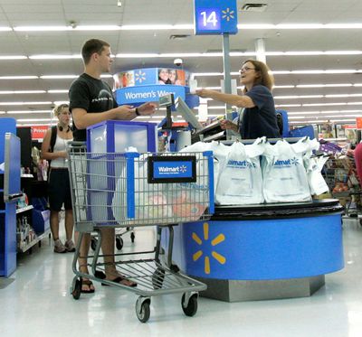 Shoppers move through the check-out line after a shopping trip to Wal-Mart in Tallahassee, Fla. Retail sales outside of autos turned in a disappointing performance in July, underscoring concerns about the timing and durability of a recovery from a deep recession. (Associated Press / The Spokesman-Review)