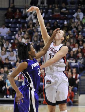 Gonzaga's Janelle Bekkering launches the last shot but does not get a foul call on Portland's Natalie Day, in the first half, Feb. 4, 2011 in Spokane, Wash. (Dan Pelle / The Spokesman-Review)