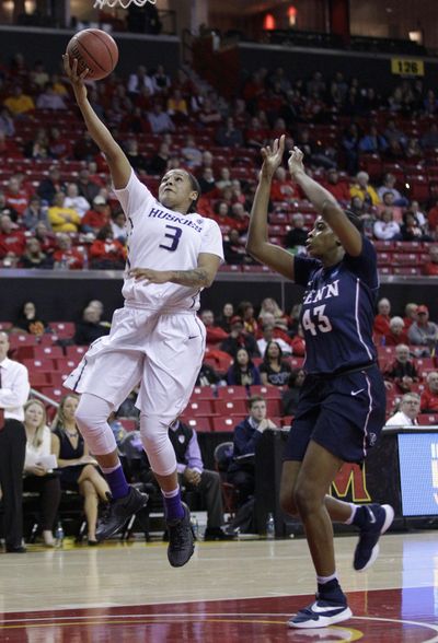 Washington forward Talia Walton  shoots over Penn forward Michelle Nwokedi in the first half Saturday. (Associated Press)