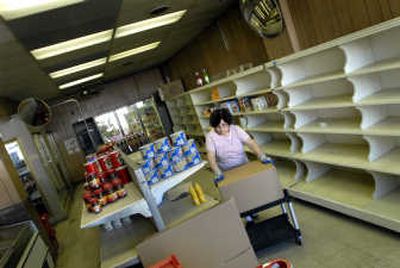 
Nancy Feinberg packs dry goods from shelves Friday at the Handy Market in downtown Spokane. Feinberg is being forced to move from the business she has owned since April to make room for renovations along the stretch of First Avenue. 
 (Photos by Brian Plonka / The Spokesman-Review)