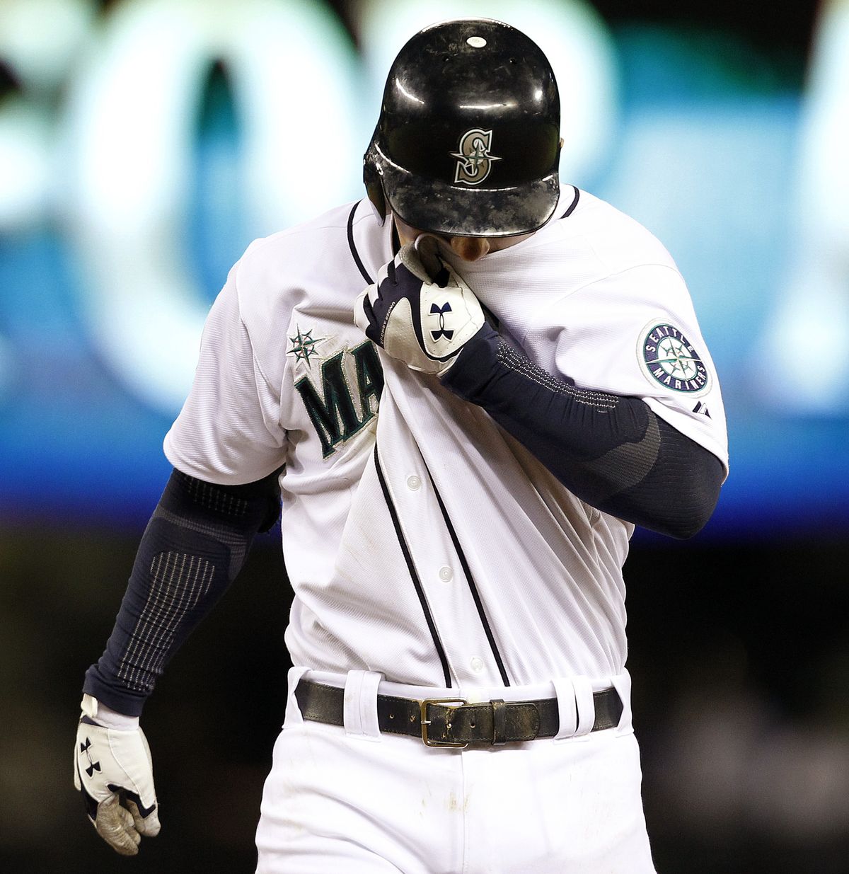 Mariners’ Kyle Seager hides his face as he walks off the field after flying out to end the game, a 2-1 come-from-behind win for Cleveland. (Associated Press)
