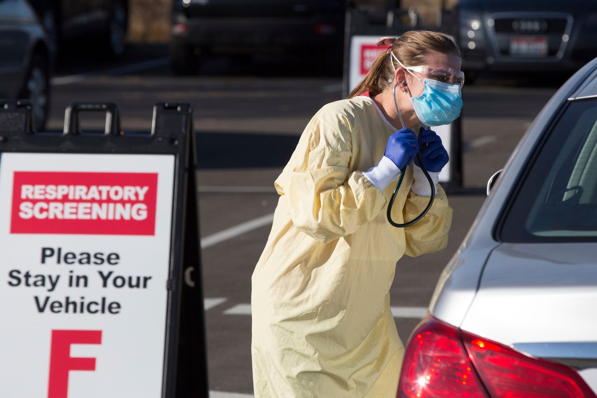 Physician assistant Nicole Thomas conducts a COVID-19 examination in the parking lot at Primary Health Medical Group’s clinic in Boise on Nov. 24, 2020.  (Otto Kitsinger)