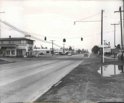A gas station will be built on the northwest corner at Division Street and Francis Avenue, which is occupied by a Richfield service station, seen on the left. The original caption for this 1955 photo described this stretch of Division as the “Road to Remembrances” and pointed out the Chinese elm trees flanking the road in the distance. “It’s hard to imagine how any motorist can drive in or out of Spokane by way of north Division without being conscious of a pressing emptiness, which must be unique in the American scheme of things. The emptiness is caused by lack of outdoor advertising signboards,” the caption read.