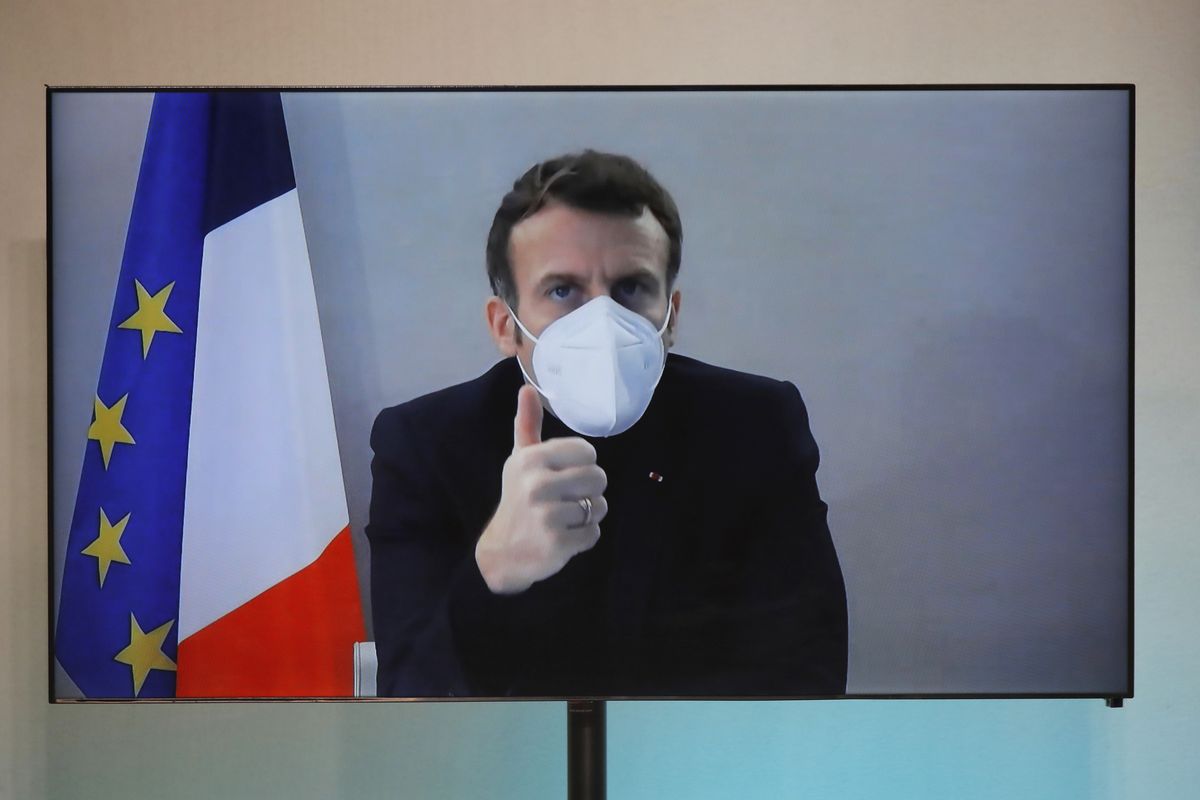French President Emmanuel Macron is seen on a screen as he attends by video conference a round table for the National Humanitarian Conference (NHC), taken at the Foreign Ministry in Paris,Thursday, Dec. 17, 2020. French President Emmanuel Macron tested positive for COVID-19 Thursday following a week in which he met with numerous European leaders. The French and Spanish prime ministers and EU Council president were among many top officials self-isolating because they had recent contact with him.  (Charles Platiau)