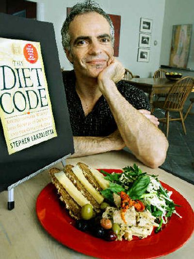 
Baker and author Stephen Lanzalotta sits in his restaurant by a plate of food that is highlighted in his book 