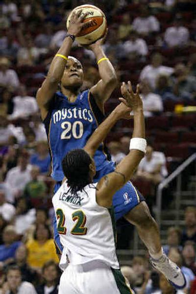 
Washington's Alana Beard goes up for a shot over Seattle's Betty Lennox during the first half on Saturday. 
 (Associated Press / The Spokesman-Review)