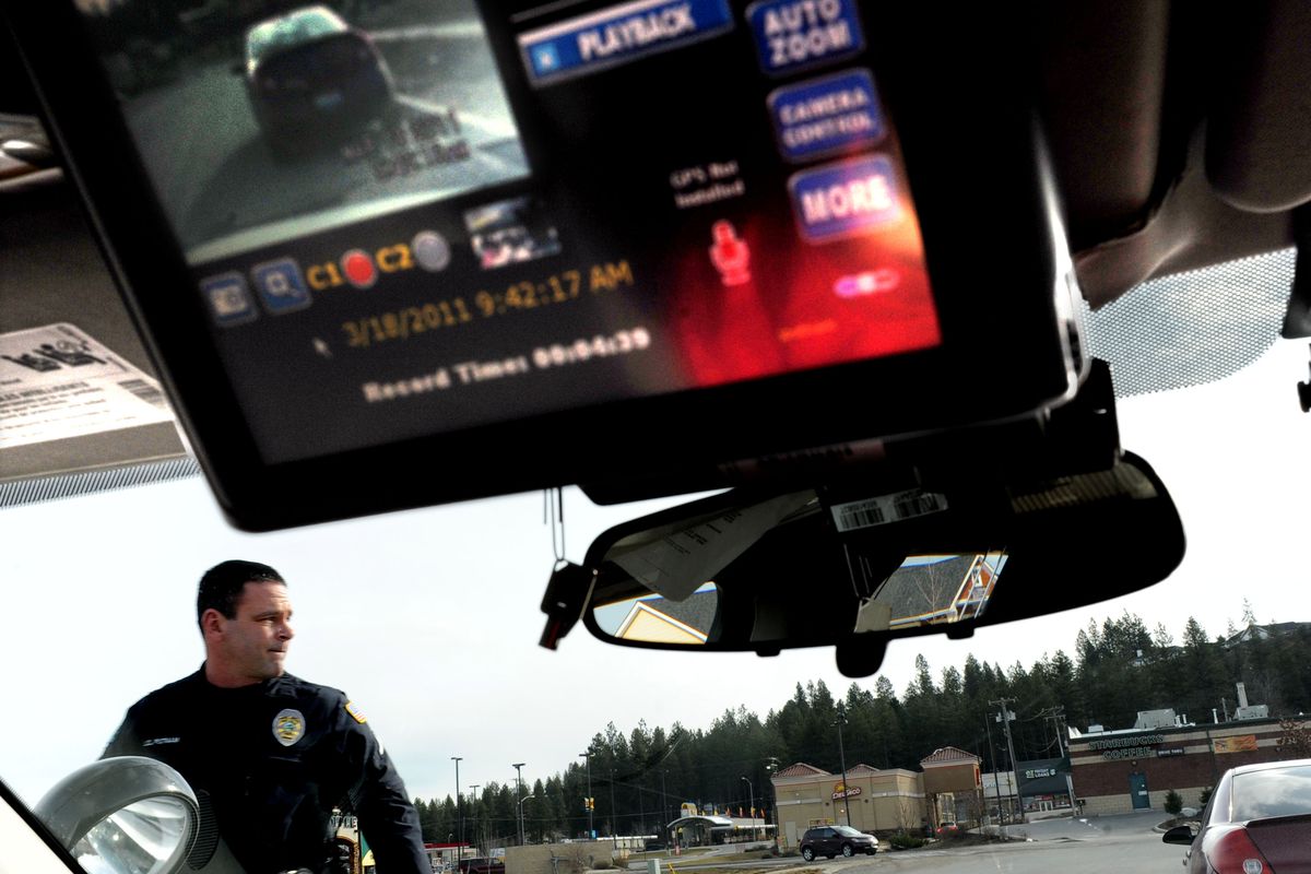 Post Falls police Officer J.D. Putnam returns to his car after a traffic stop on Friday. The department uses Coban in-car cameras to record every stop officers make. (Kathy Plonka)