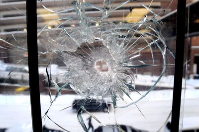 Bullets penetrated a two-paned window on the second floor at Spokane City Hall. No one was injured when the six rounds were fired over the weekend.   (Liz Kishimoto / The Spokesman-Review)