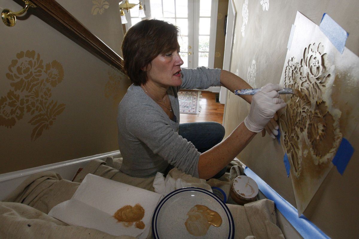 McGranaghan paints a stenciling project in a client’s Annapolis, Md., home.