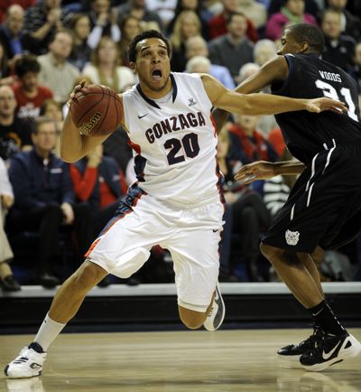 Gonzaga forward Elias Harris (20) heads to the basket past Butler forward Kameron Woods. Harris had 19 points. (Colin Mulvany)