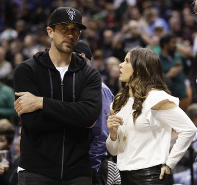 Danica Patrick talks to Green Bay Packers’ Aaron Rodgers during the first half of Game 3 of an NBA basketball first-round playoff series between the Milwaukee Bucks and the Boston Celtics Friday, April 20, 2018, in Milwaukee. (Morry Gash / Associated Press)