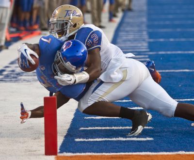 Tulsa’s Curnelius Arnick pushes Boise State’s D.J. Harper out of bounds just short of the goal line. (Associated Press)
